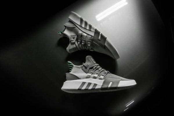 grayscale photo pair of adidas shoes