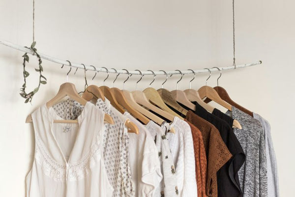 assorted clothes in wooden hangers